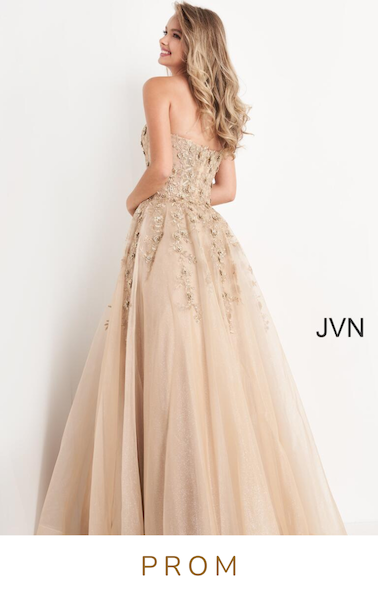 woman in strapless gold prom dress with tulle skirt and sparkles