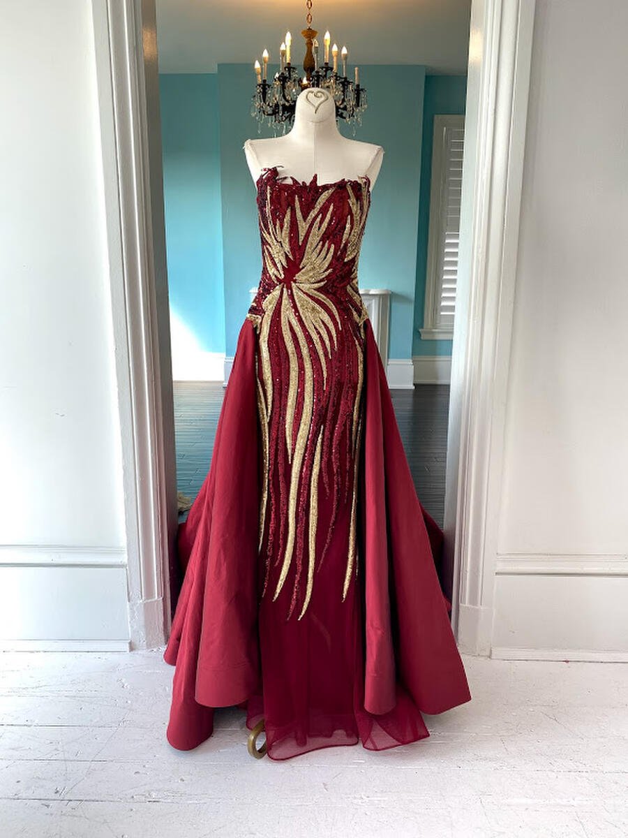 Juan Carlos Pinera red straight gown with overskirt