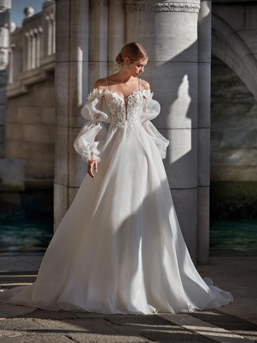 Turia Bridal Ballgown with lace accents and sleeves Nicole Milano 